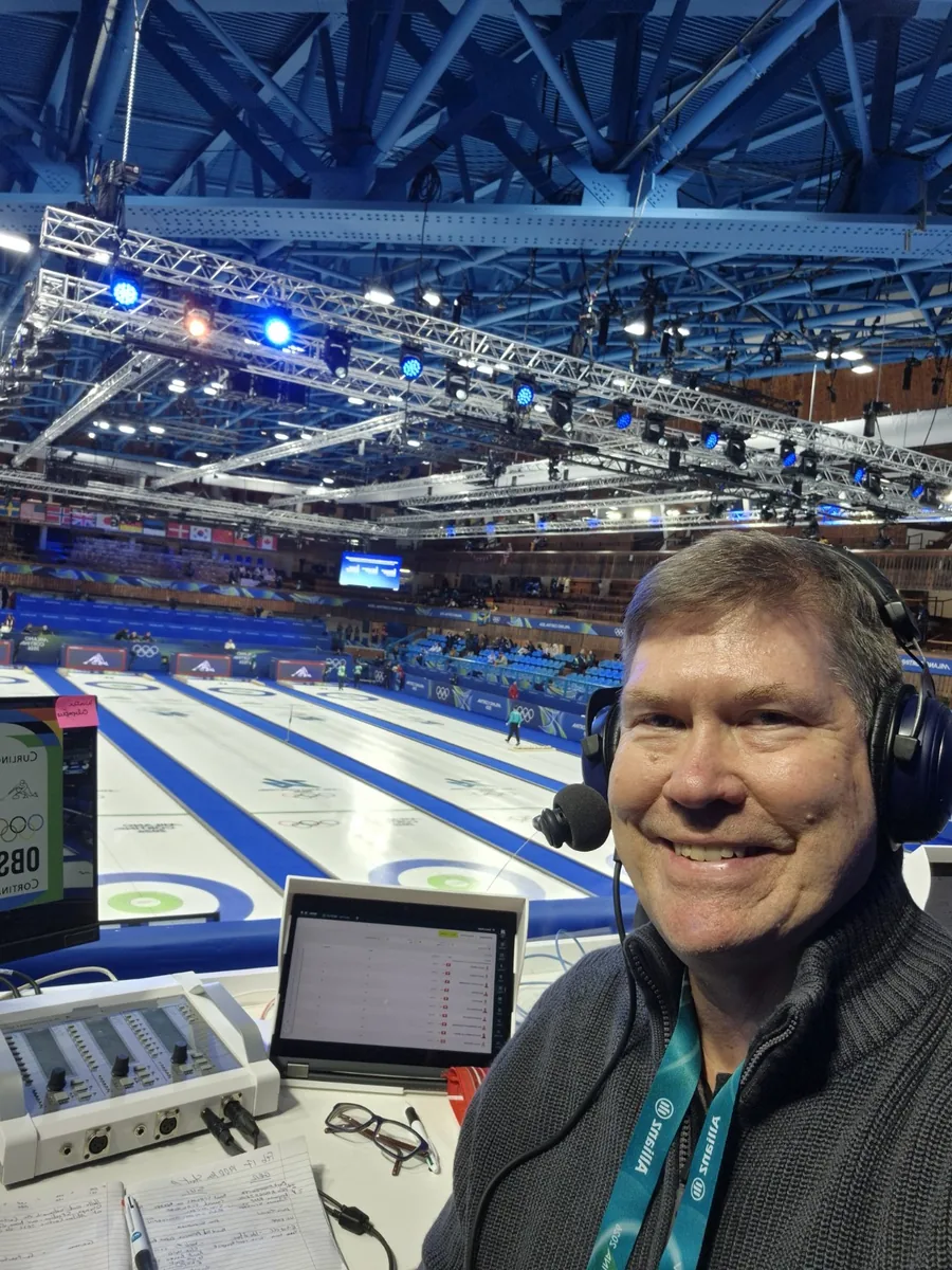 Hans Frauenlob commentating curling from an Olympic venue.