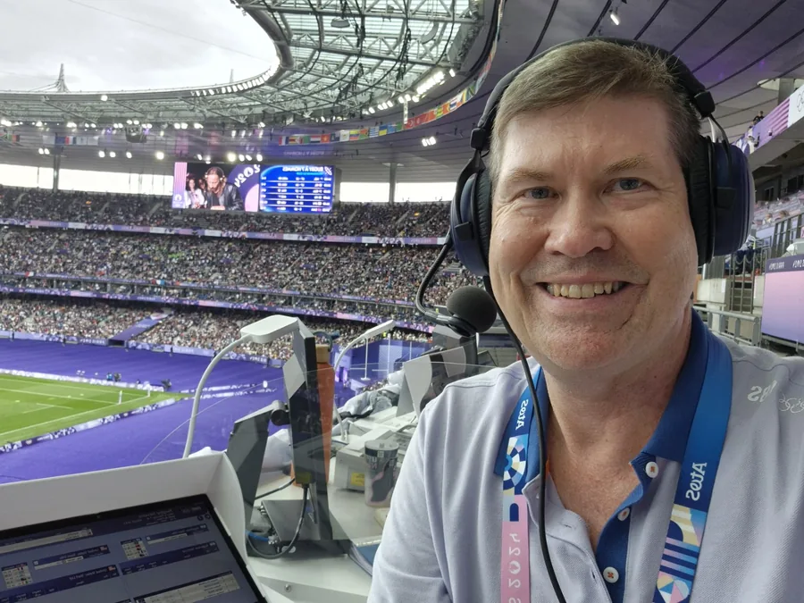 Hans Frauenlob wearing a headset at Stade de France during Paris 2024 rugby sevens.