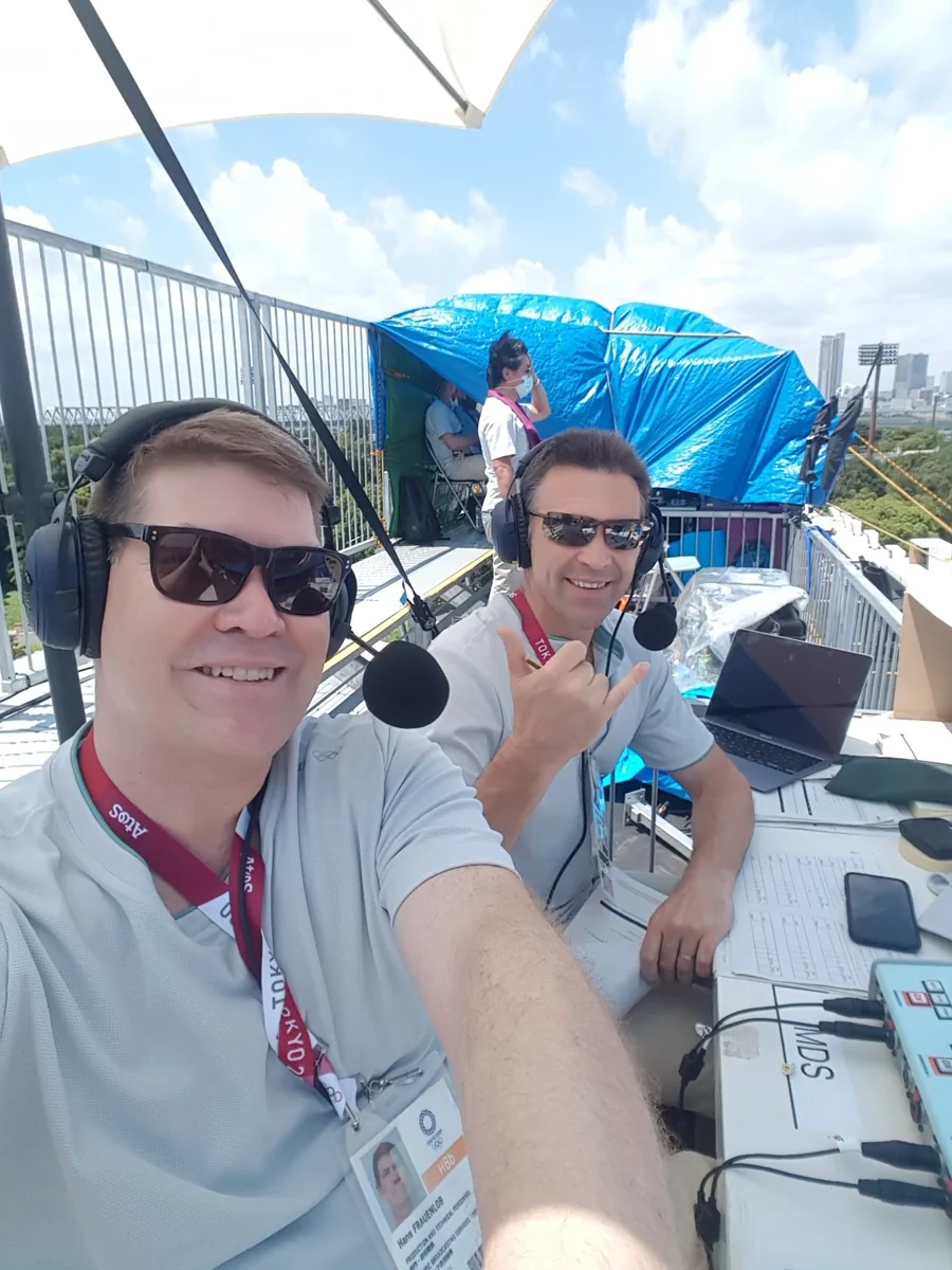 Hans Frauenlob working outdoors on commentary at Tokyo 2020 with a fellow commentator.